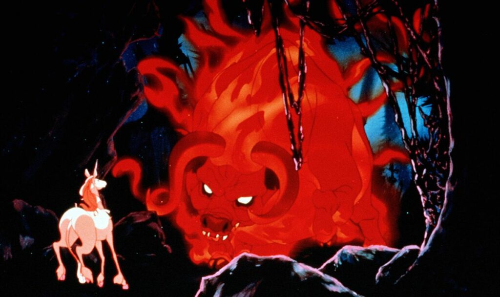 A glowing red demonic bull with curved horns advances toward a small white unicorn in a dark cavern surrounded by twisted branches and blue-tinted rock formations